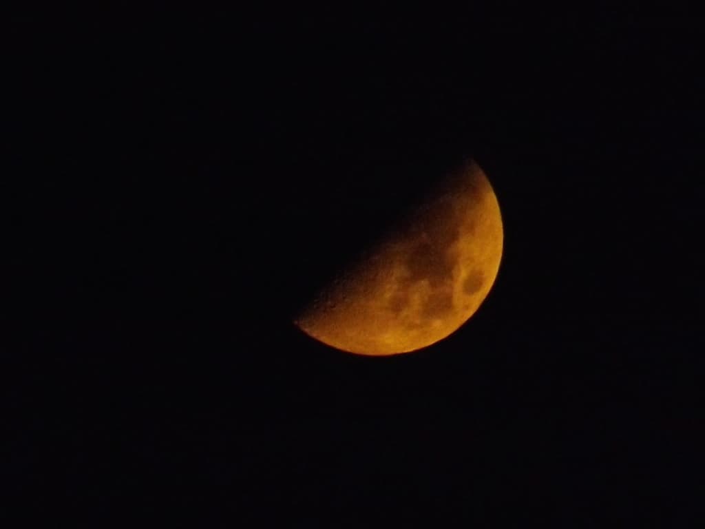 Quartier de lune orangé peu avant minuit